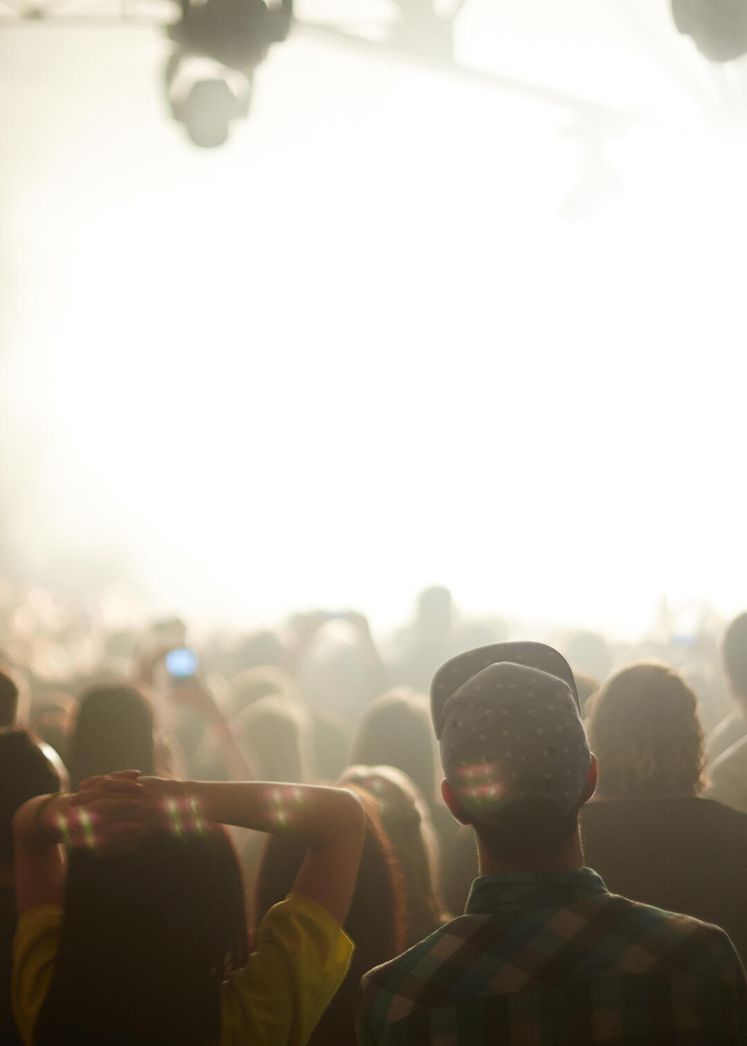 Couple standing in a crowd at an event or concert, hotel blog post ideas, travel blog post ideas, local experiences and events